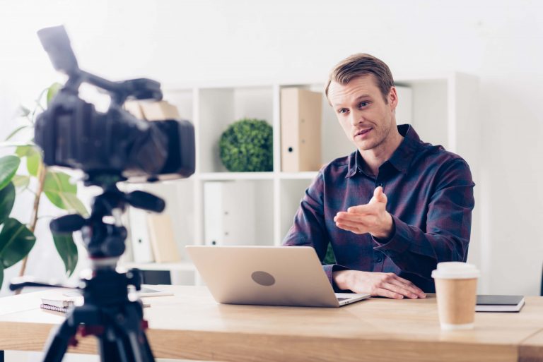 cheerful male blogger recording