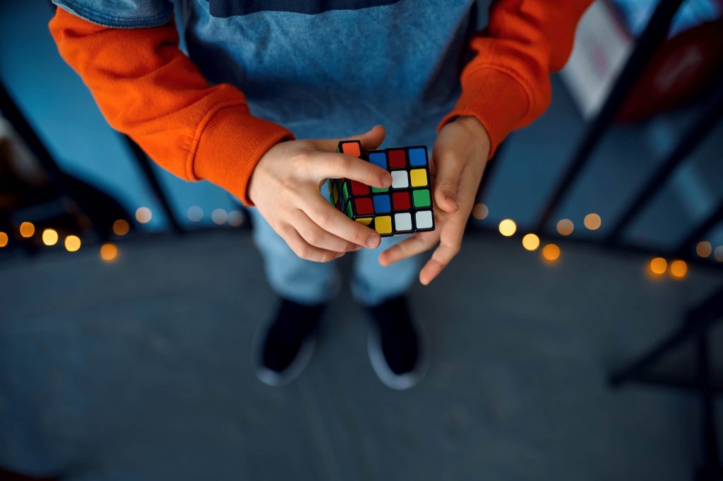 kid holding puzzle cube