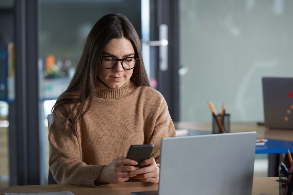 woman with phone at office